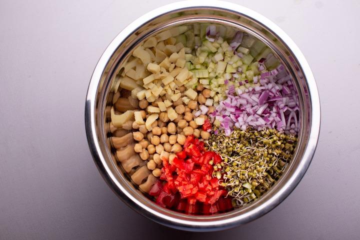 Add potatoes, cucumber, onions, mung bean sprouts and tomatoes.