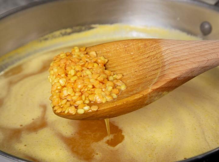 Add lentils in a wok to cook.